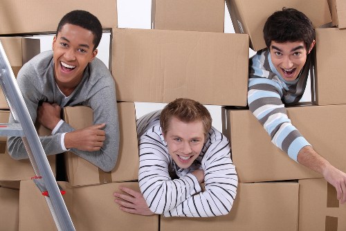 Packed boxes and furniture ready for transport by moving van in Brixton