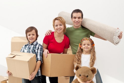 Careful wrapping of fragile items during a Brixton packing service
