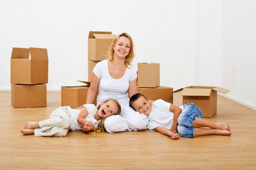 Commercial movers handling desks and equipment for a local office move