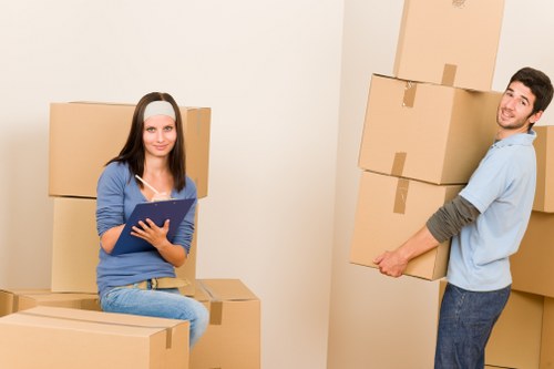 Moving team handling desks and boxes during a Brixton office relocation