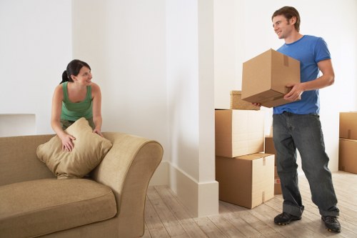 Local removals team carrying items from a Brixton flat